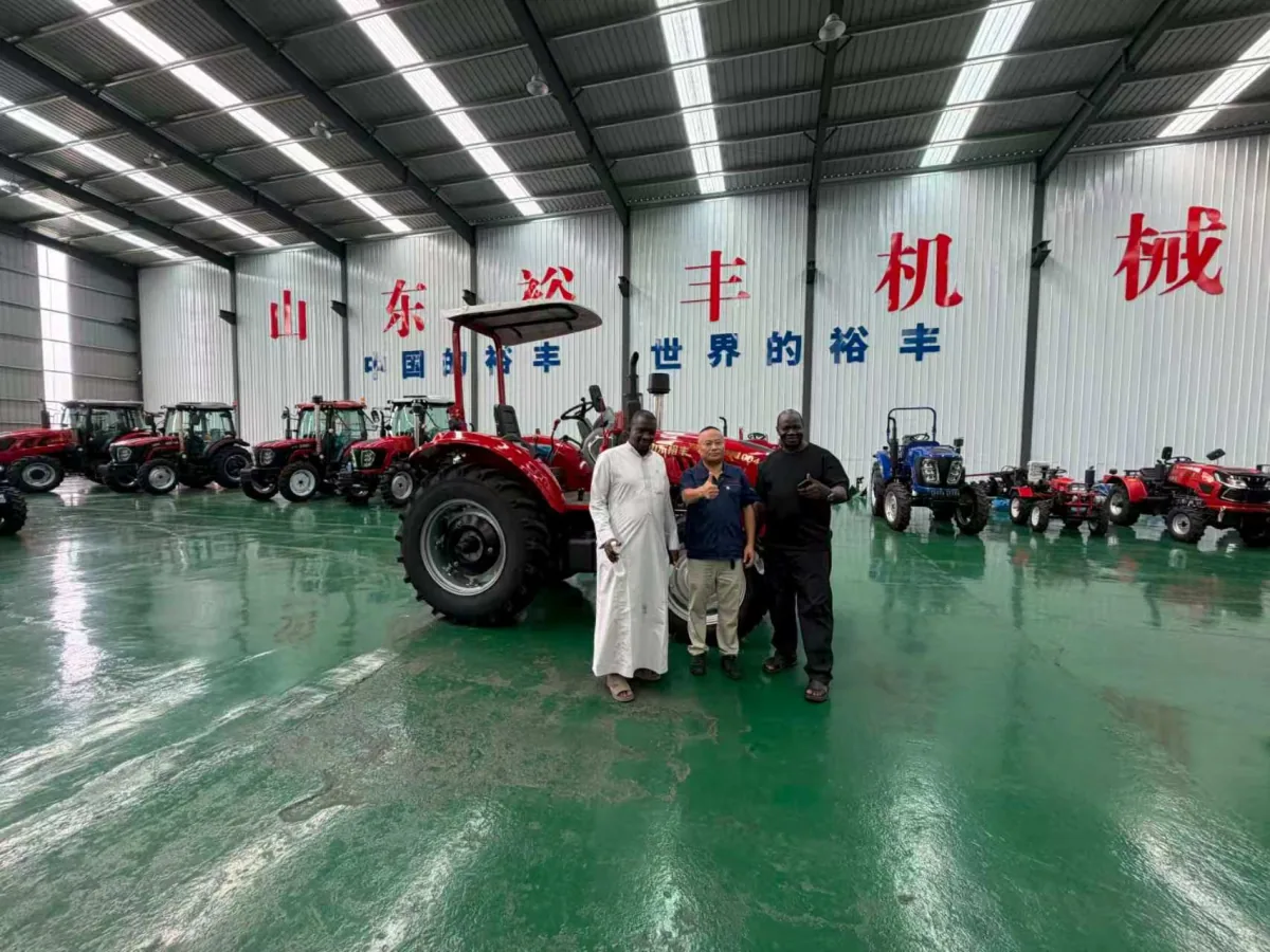 Customers touring HETIAN tractor models inside the factory